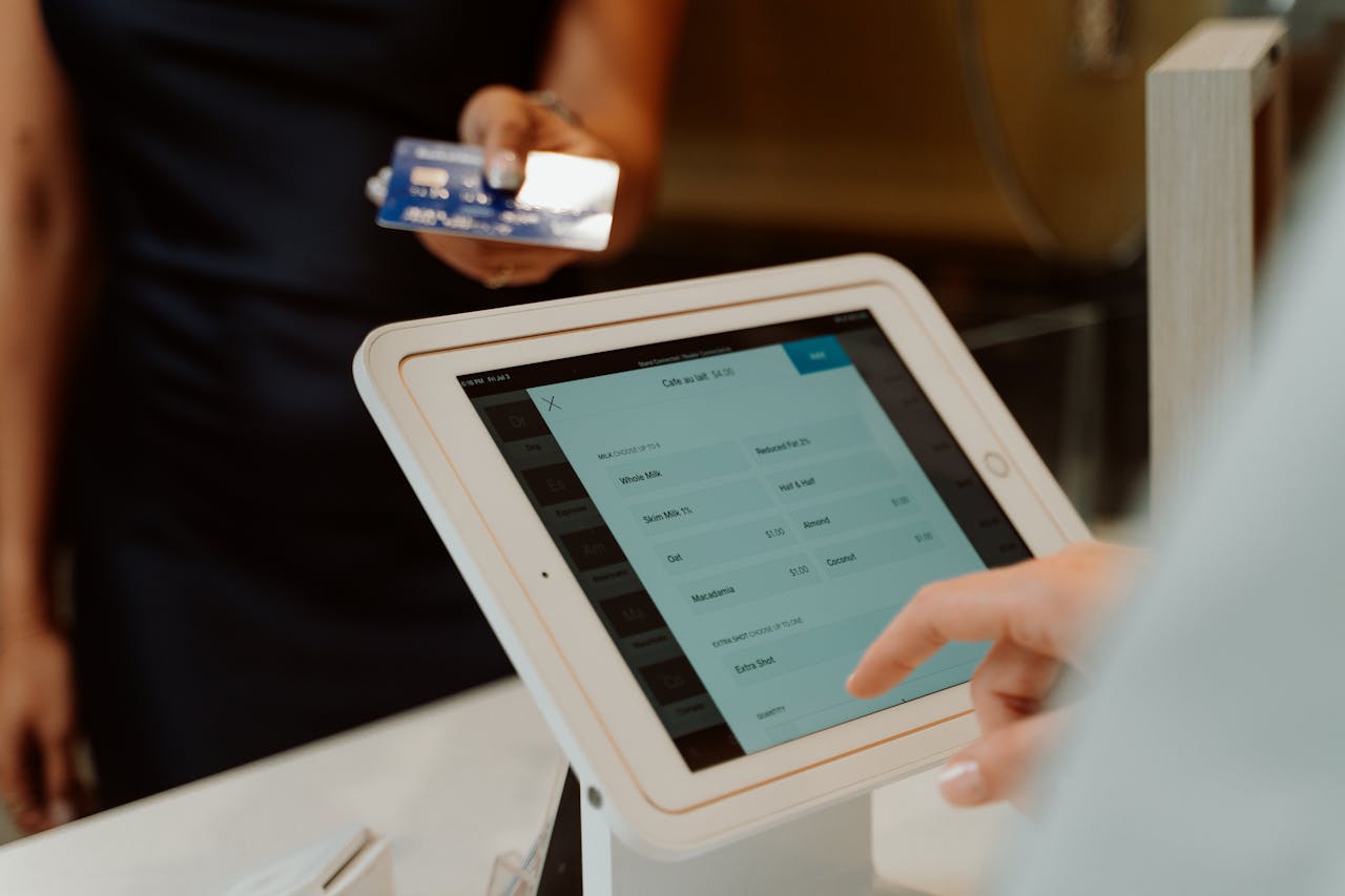 about-us-01 A modern cashless payment system using a tablet and card for seamless transactions.